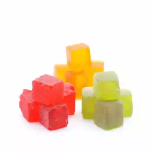 Medicated Hard candies. Comes in packs of 4. Sets of square red, green and orange sit on a white background. 