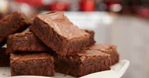 Keto brownies stacked up on the left side of the picture.