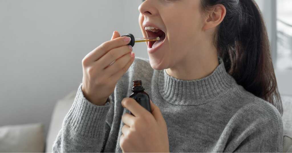 CBD oil - oral treatment for glaucoma - cannabis oil - woman - drops in a bottle