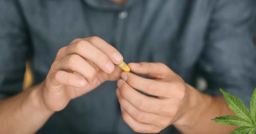 Cannabis treatment for ADHD - Man taking capsules - THC - CBD