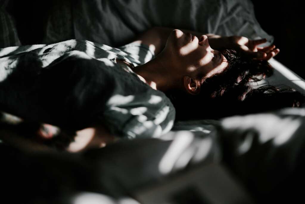 Insomnia- person on the bed no sleep- dark- light
