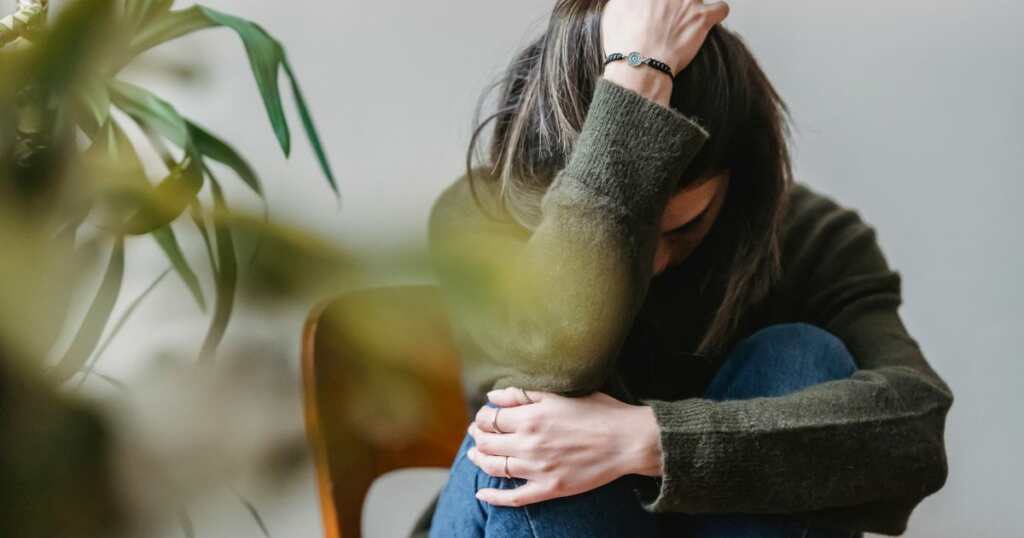 Woman with social anxiety touching her hair
