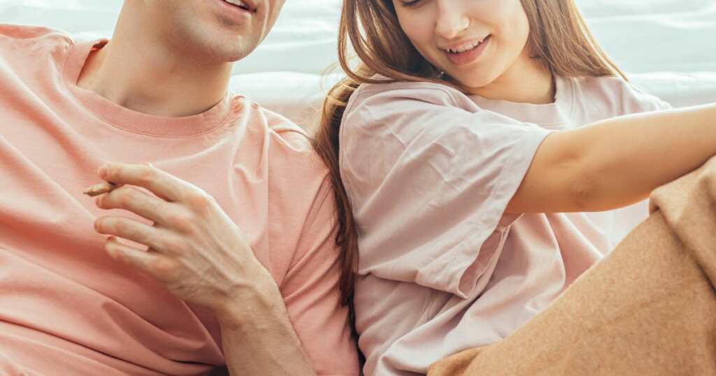 couple smiling with a joint - cannabis stain - smoking