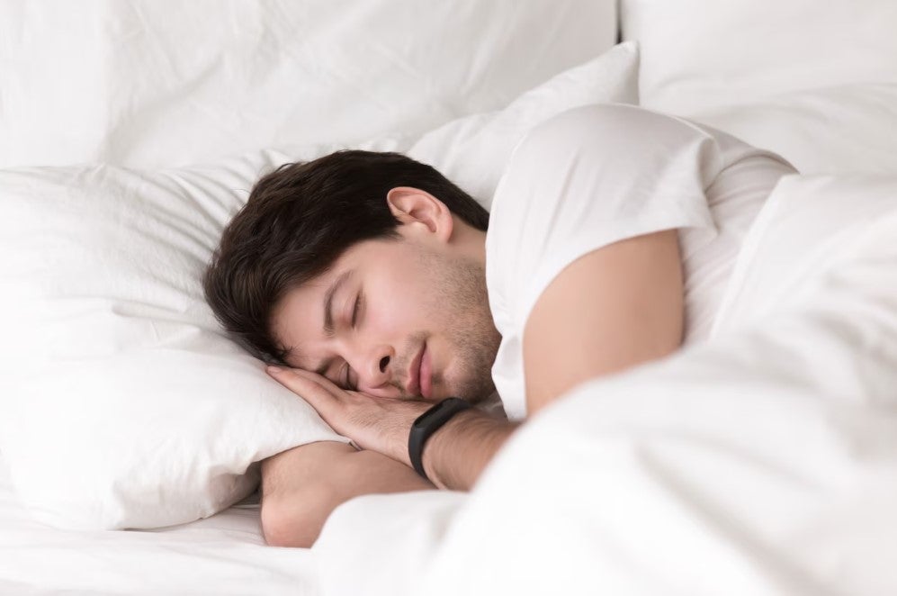 sleeping-relief-insomnia-man-resting in bed- white sheets -strain - Indica