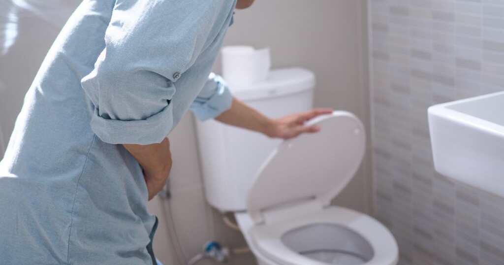 Man with nausea - WC - touching his stomach
