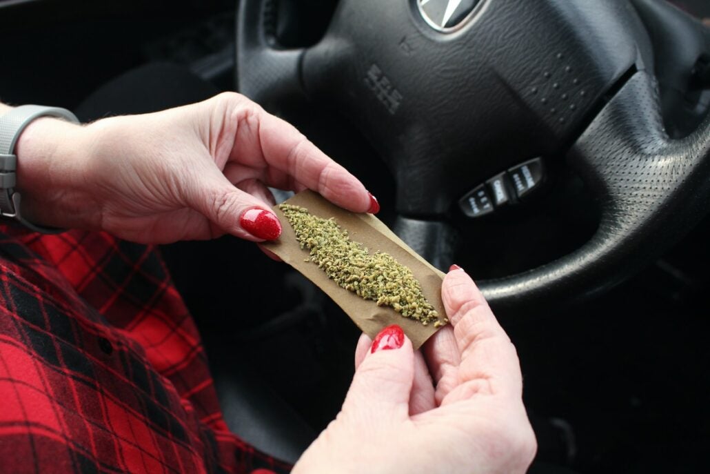 Rolling a joint inside car.