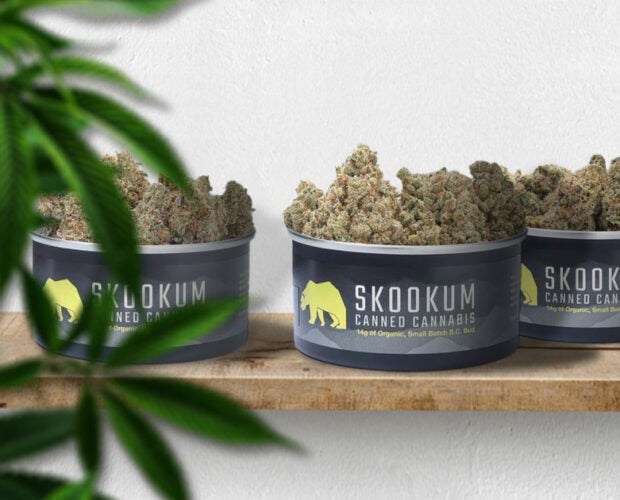 Skookum review featured photo. 3 skookum premium cannabis tins sit on a wooden board.