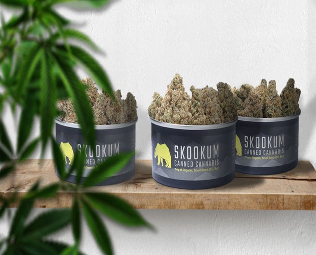 Skookum review featured photo. 3 skookum premium cannabis tins sit on a wooden board.