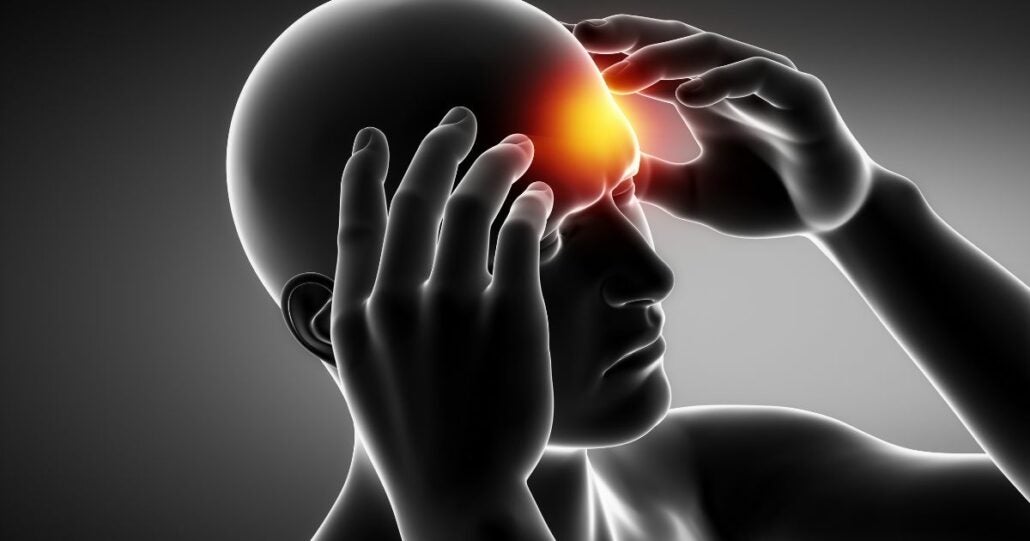 A picture depicting a migraine attack. There is a red pulsing spot on the head of the person.