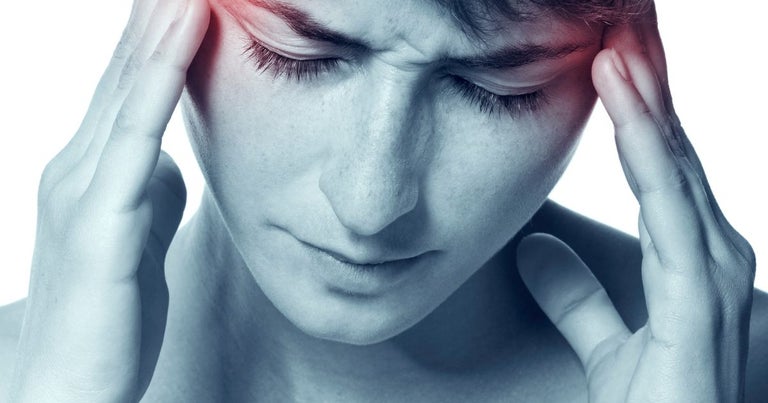 Young woman suffering from a migraine.