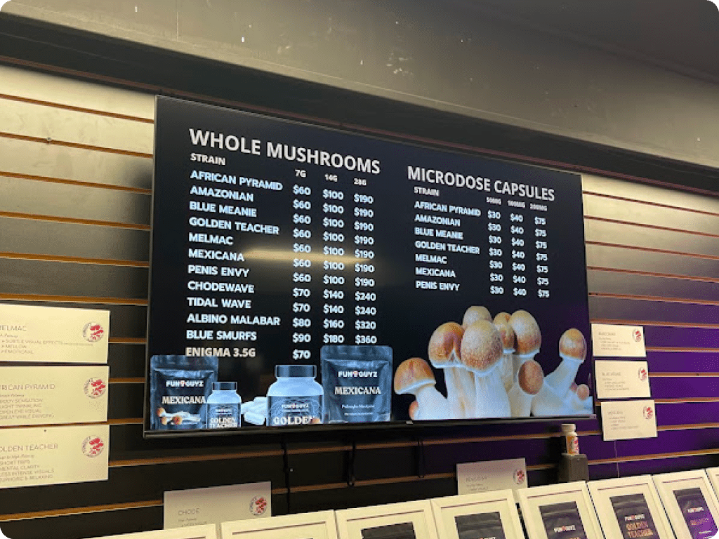 A TV menu displaying in-store prices at Funguyz Magic Mushroom Dispensary on Queen Street East