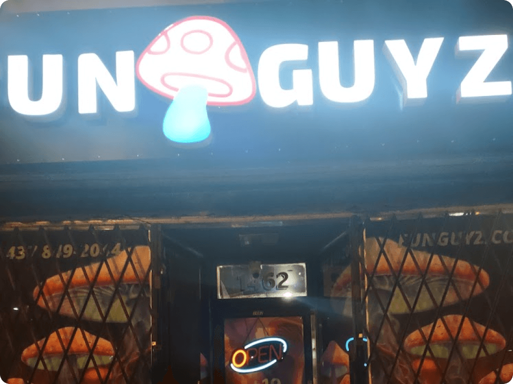 Bright sign with Funguyz logo on the Funguyz magic mushroom dispensary on Queen Street West