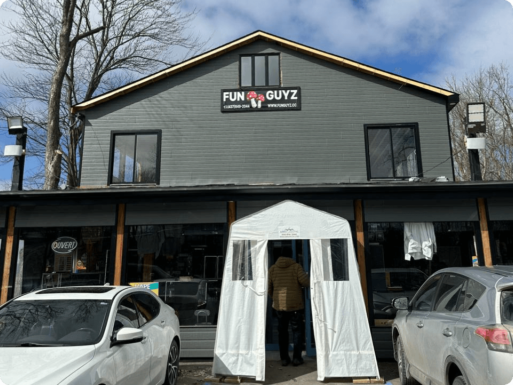 Th ebuilding and clear street signage with Funguyz logo at Funguyz magic mushrooms dispensary in Montreal