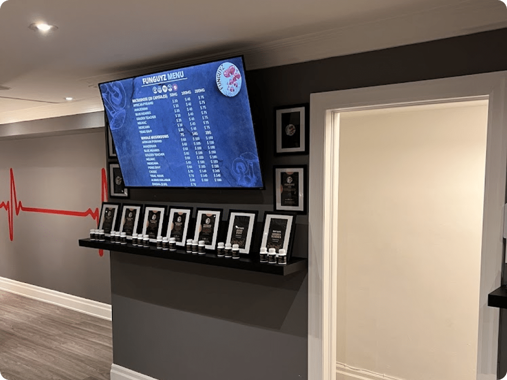 Funguyz North York, store at 1938 Avenue Rd, a TV with a menu and shelves with products
