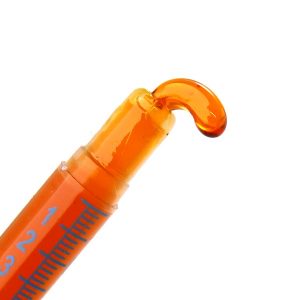 Orange Honey Oil coming out of a syringe.
