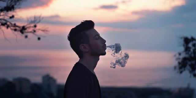 Man exhaling Co2 oil vape