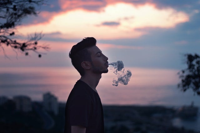 Man exhaling Co2 oil vape