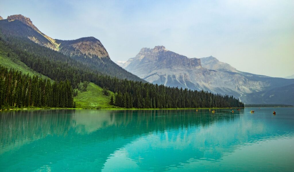 beautiful sky blue weather, clear blue lake with forested mountain looming in the back an ideal climate to grow weed