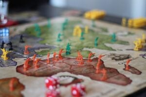 A picture of a board game with a map of countries and soldiers on countries.