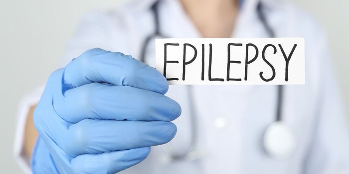 Doctor holding up a note saying "epilepsy".