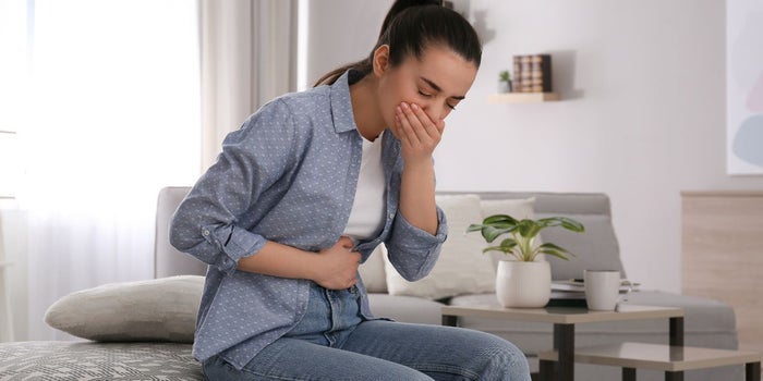 Young woman suffering from Chemotherapy-induced nausea.