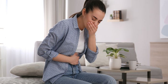 Young woman suffering from Chemotherapy-induced nausea.