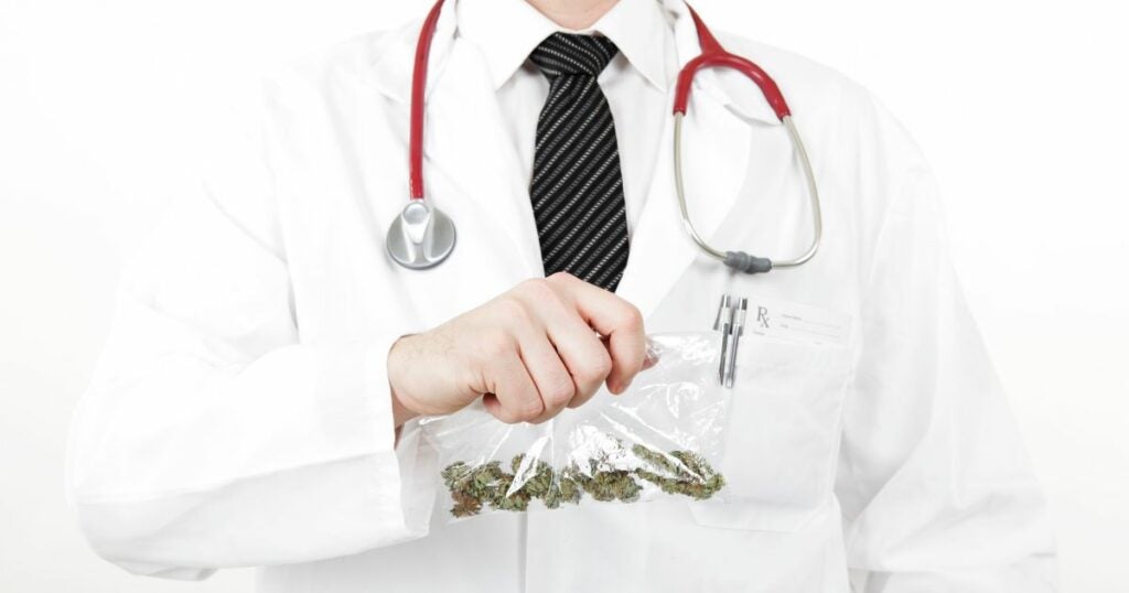 Doctor with a bag of cannabis in one hand.