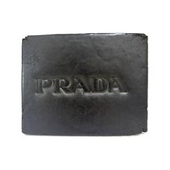 Slab of Hive Prada Hash with the word 'PRADA' embossed into its grey surface, newer photo
