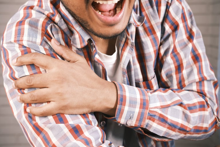 man having pain in the arm