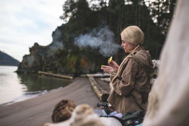 Young lady smoking shatter outdoors.