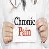 Doctor holding up a paper that reads chronic pain.