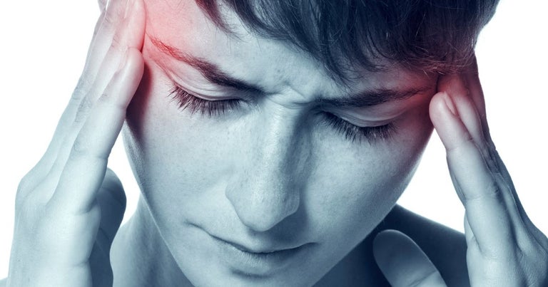 Face of a person with migraine in red - headache - close up