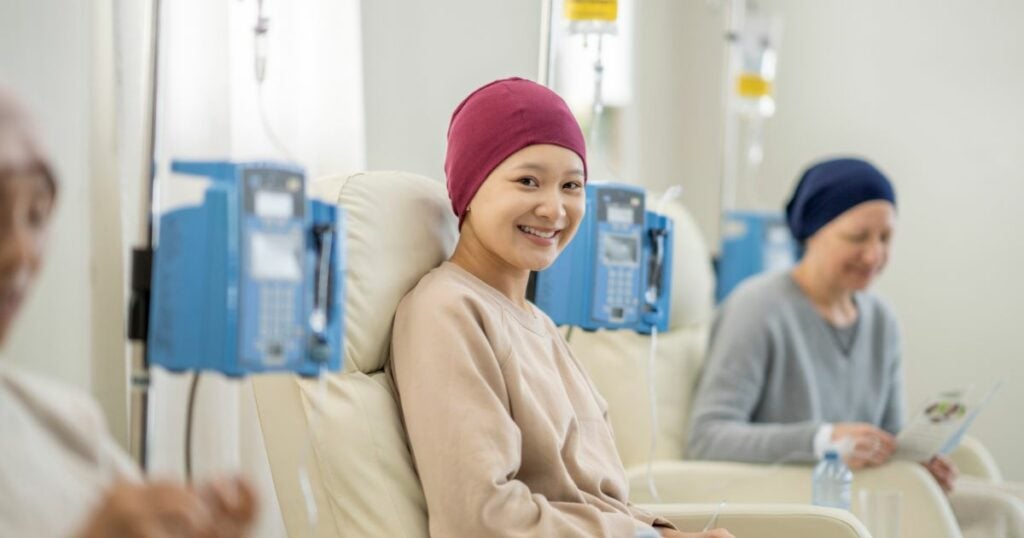 Woman with cancer - chemotherapy - cannabis treatment - smiling - nausea relief - hospital
