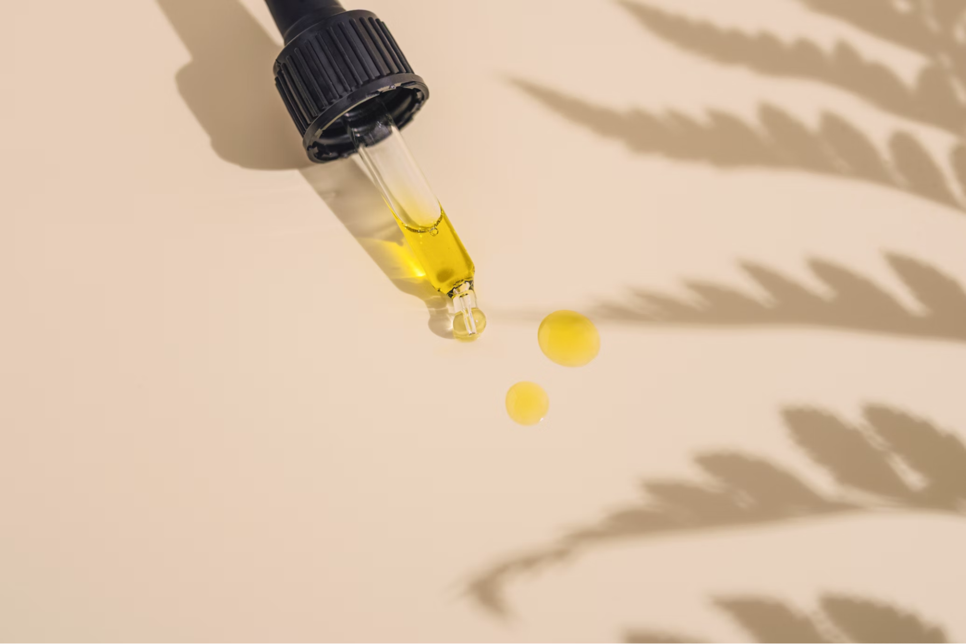 CBD Oil in a syringe, on a beige background.
