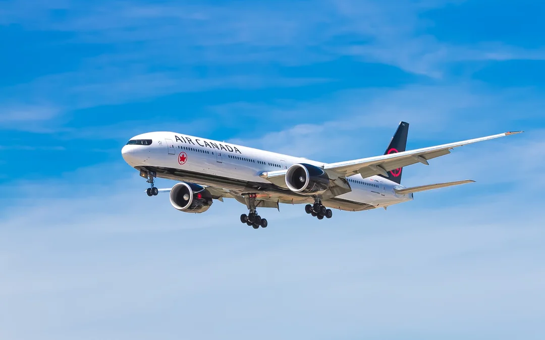 Air Canada flight. Airplane flying in a blue sky with no clouds.