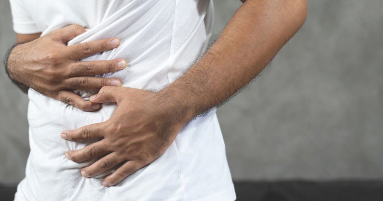 Cannabis Crohn's Disease-man-with-stomach-ache-hands-holding-touching-his-stomach