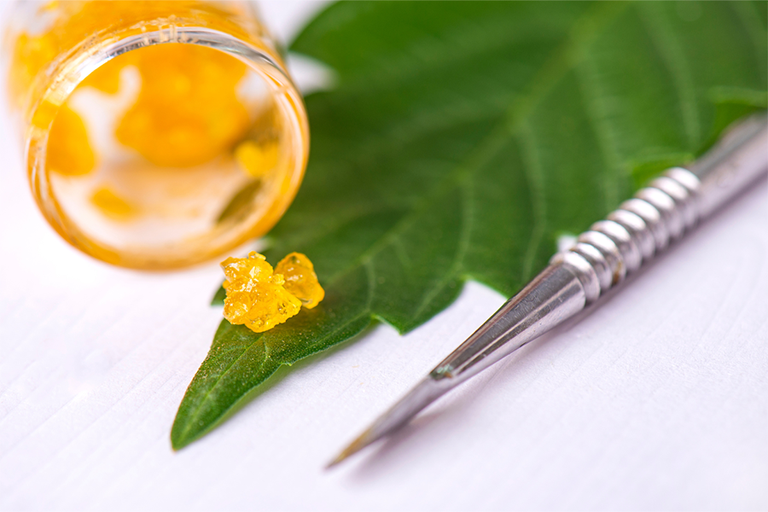 Cannabis extracts placed on hemp leaf